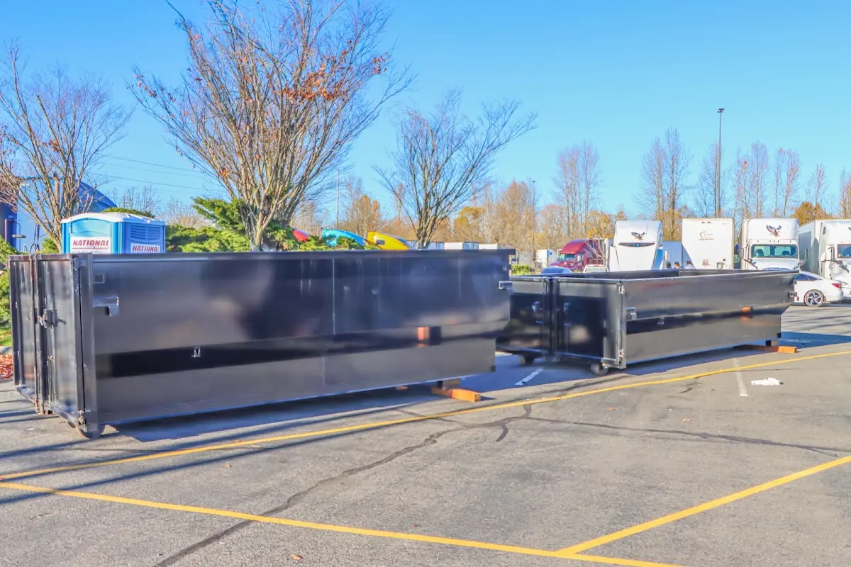 Professional dumpster rental service with roll-off container on residential driveway in Moosic